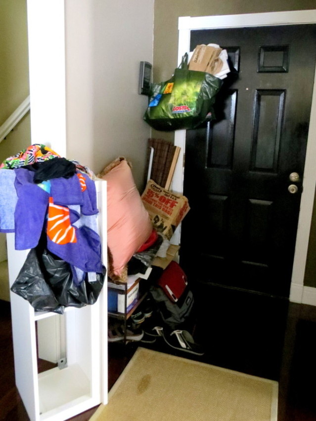 A cluttered small entryway mess.